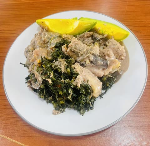 A plate of greens, protein and avocado