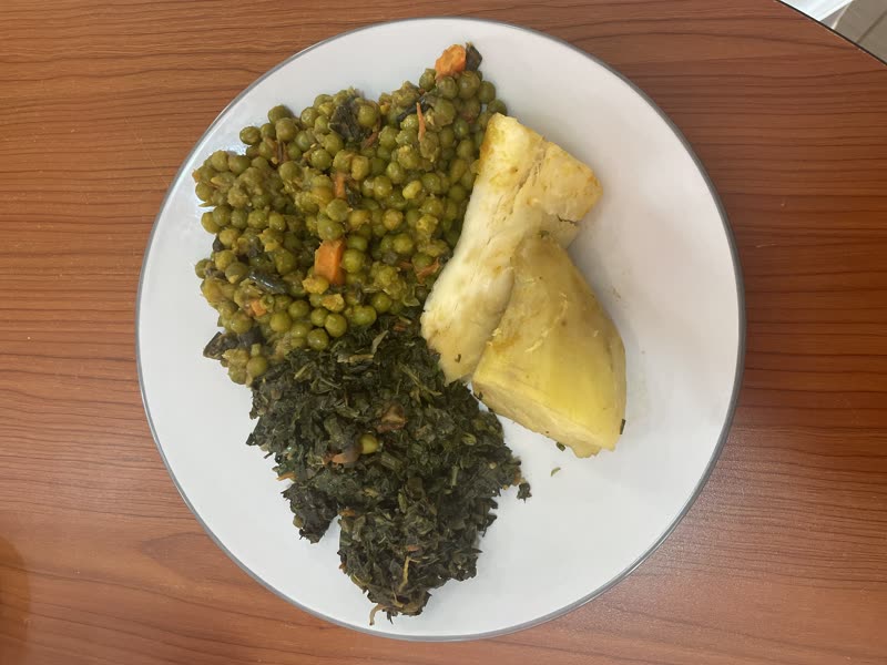 A plate of peas, greens and cassava