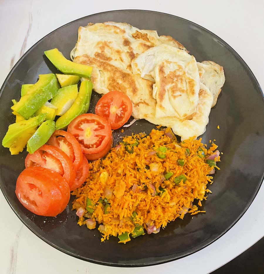 A plate of chapati, eggs and tomatoes prepared the Eat Better UG way