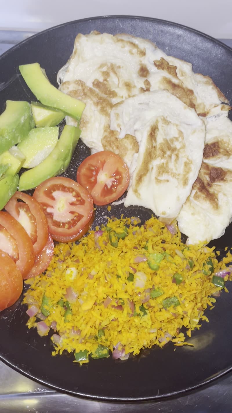 A plate of chapati, avocado, tomato and rice prepared the Eat Better UG way